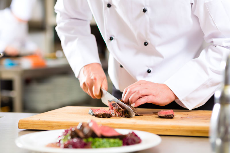 chef cutting meat